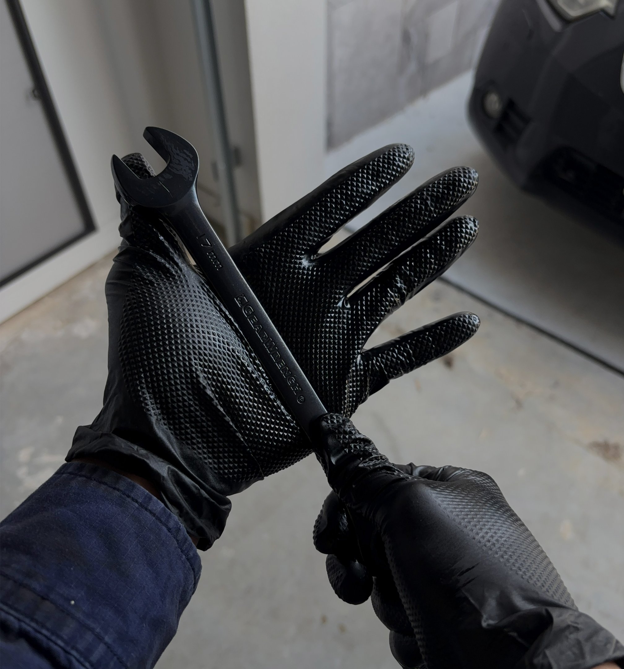 Tradie wearing BLACKPALM gloves on a wet or greasy job