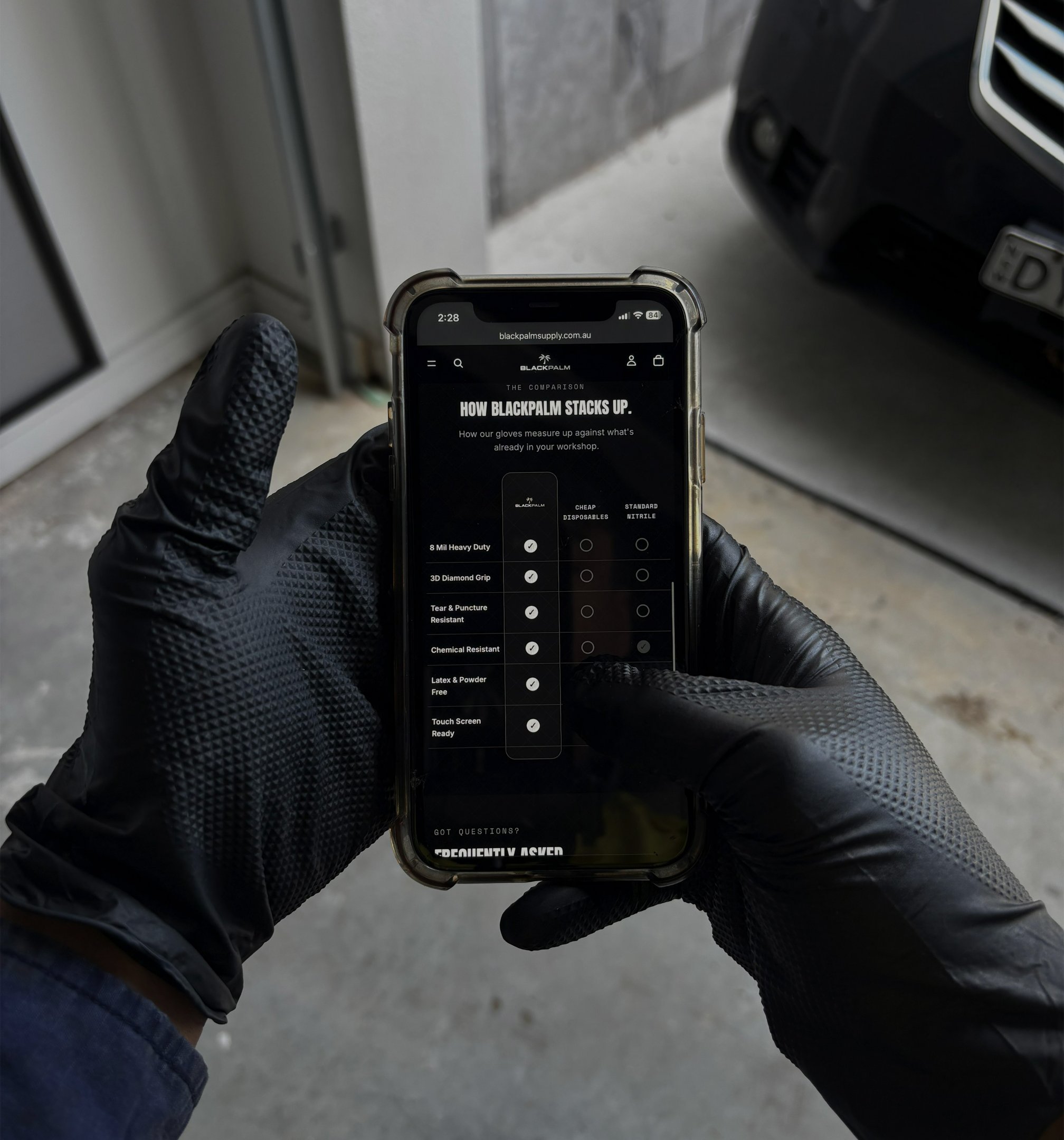 Tradie using a phone while wearing BLACKPALM gloves