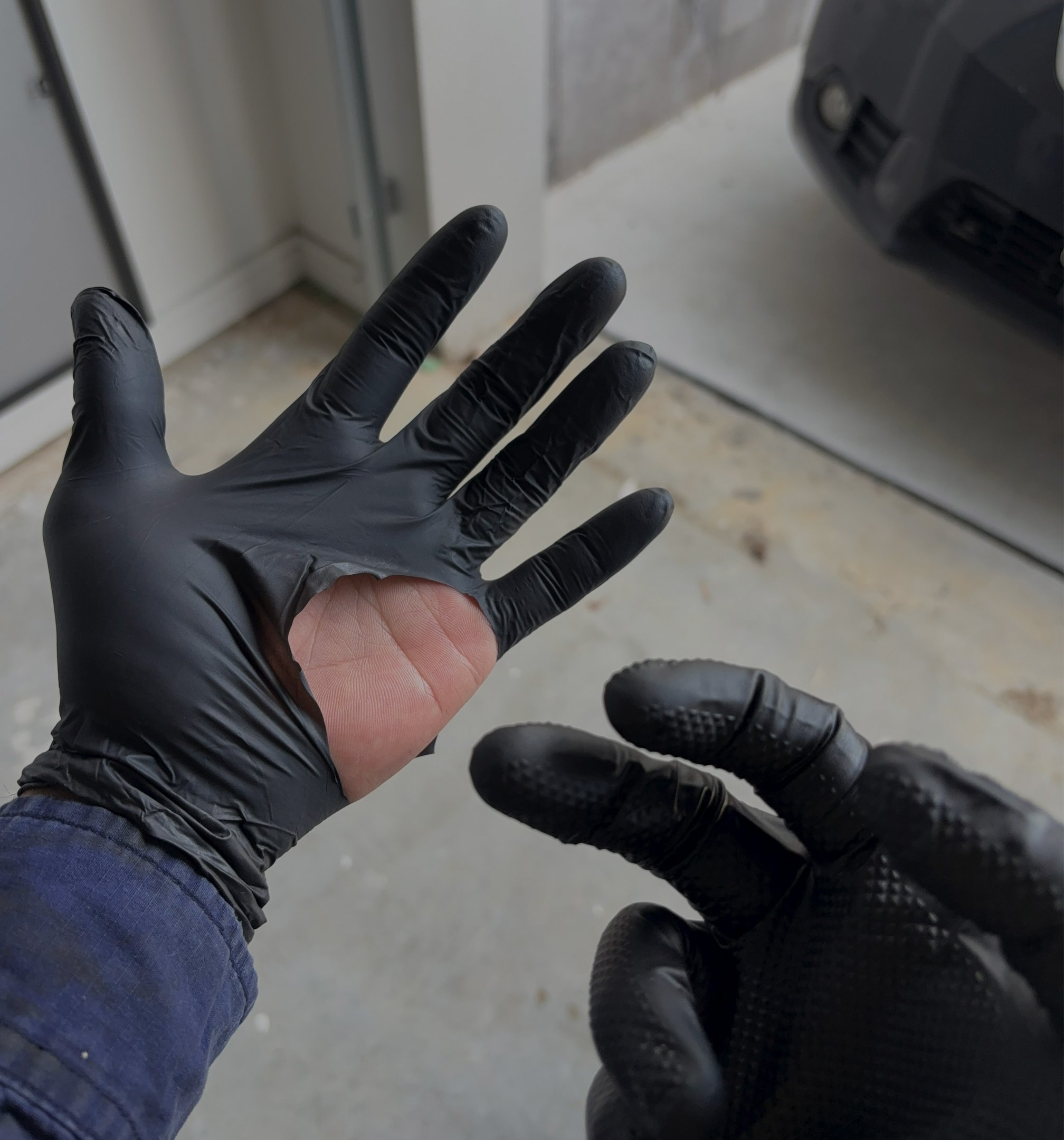 Torn cheap disposable glove after use