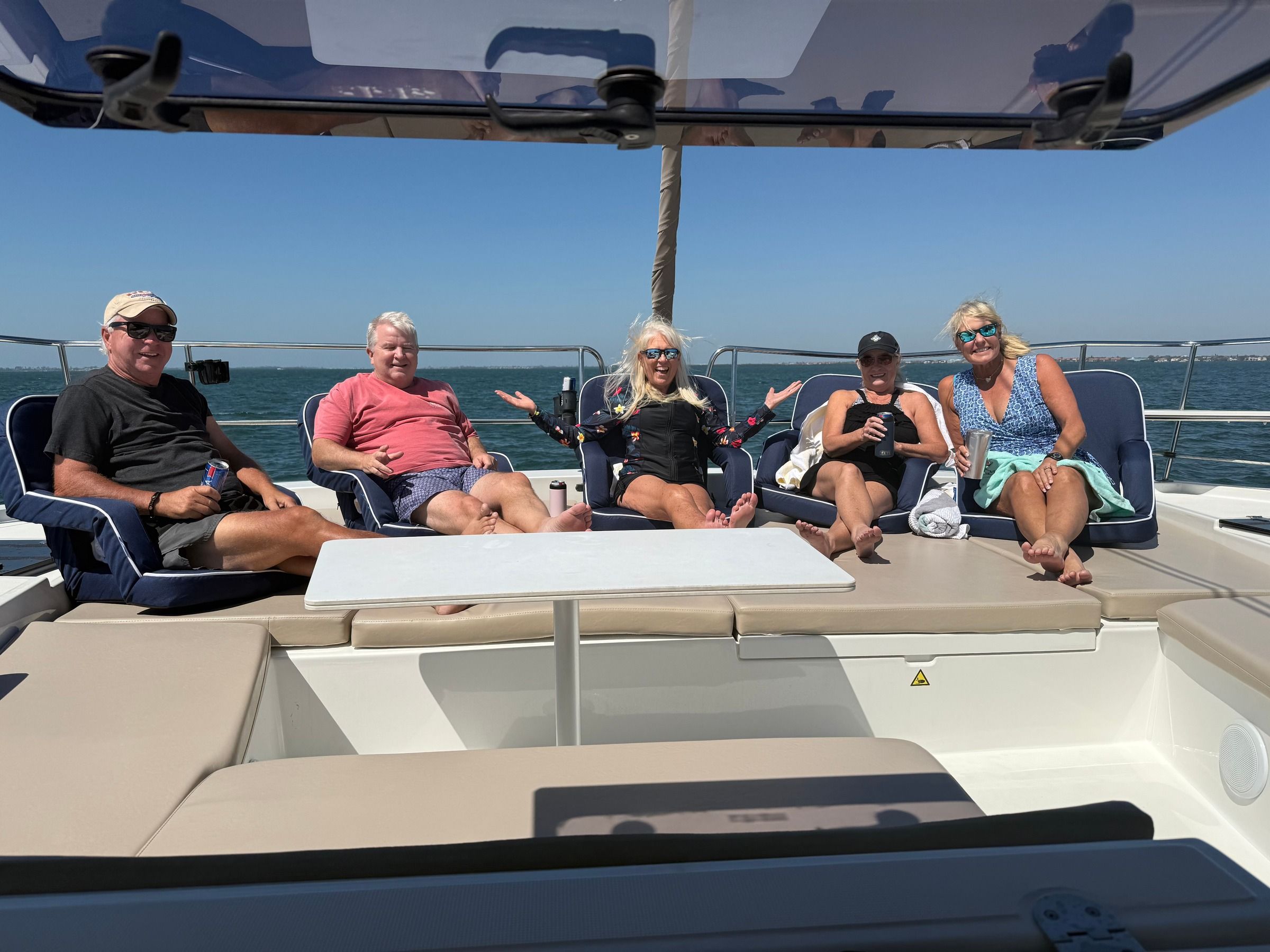 Group celebrating on a boat at sunset