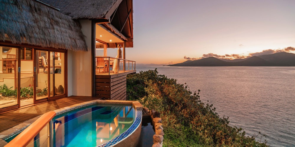 Clifftop villa with a private plunge pool overlooking the sea at sunset in Fiji