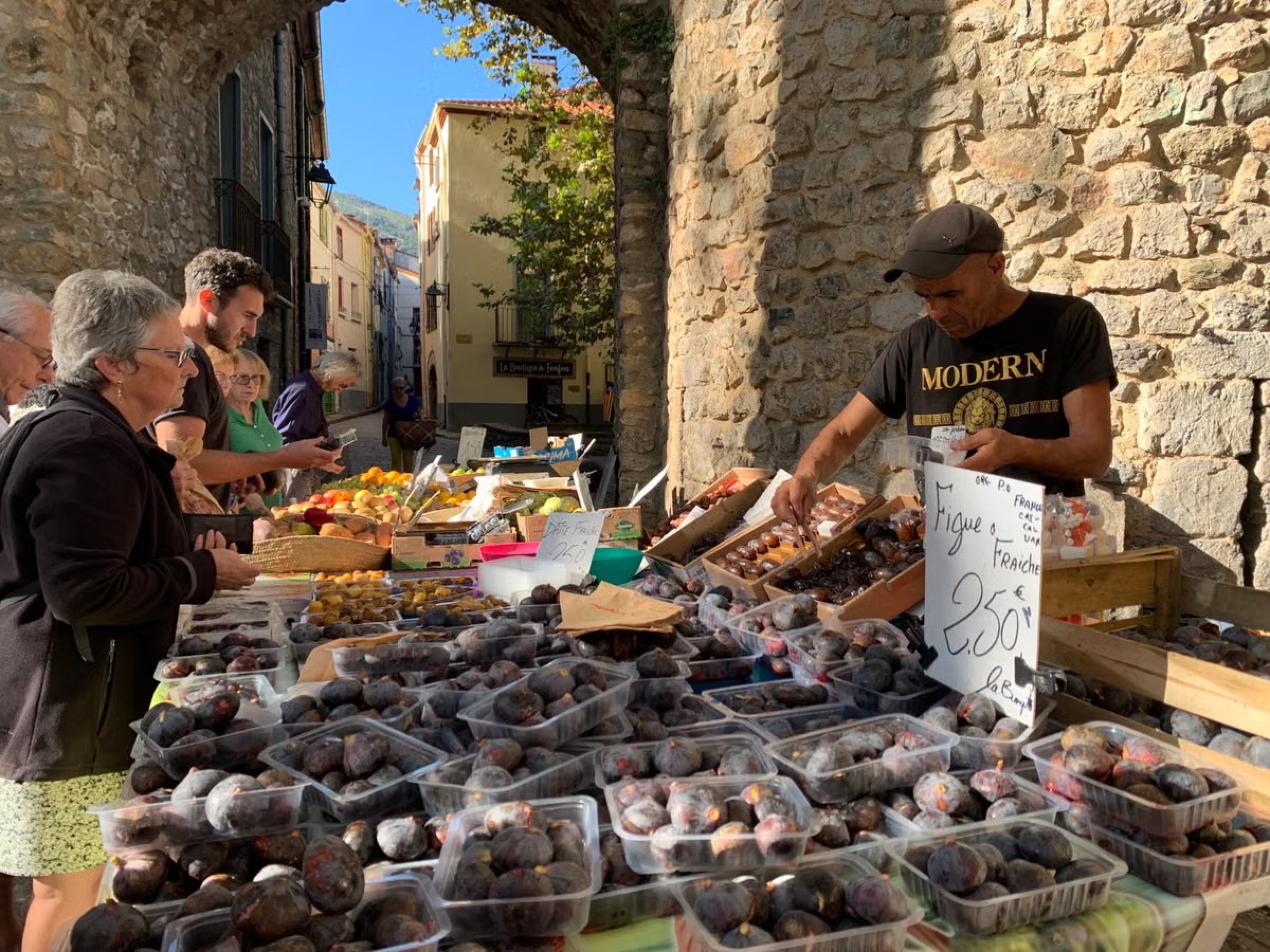 A stallholder selling figs at a French village market