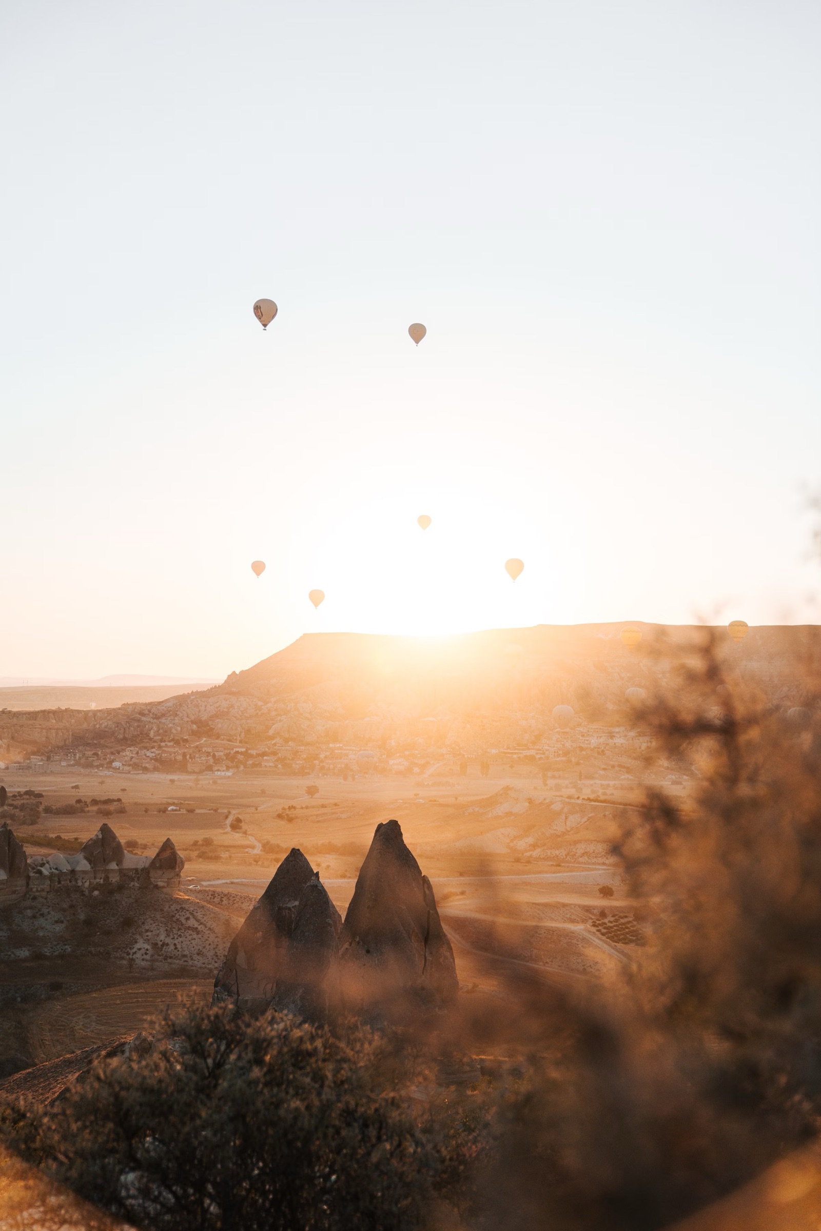 Hot-air balloons drifting over Cappadocia’s fairy chimneys at sunrise
