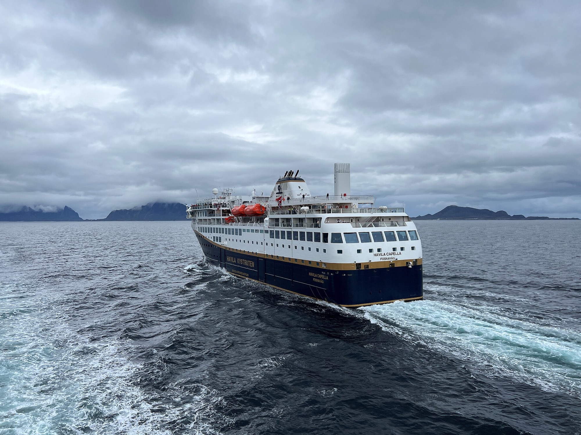 A Havila coastal ship sailing past the Lofoten Islands